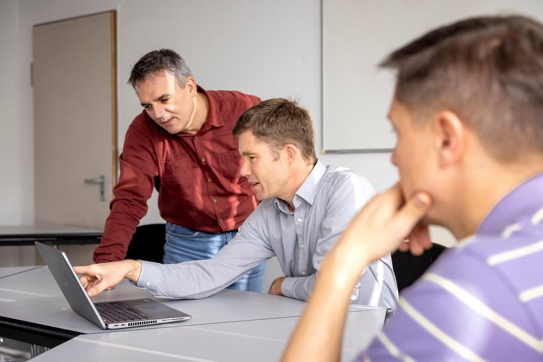 Data analysts working on project Employees discussing data analysis and software programming project